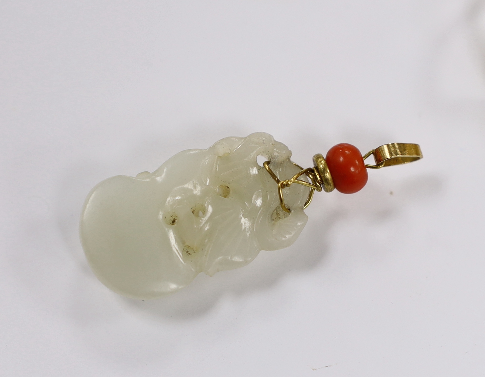 A yellow metal and coral bead mounted carved jade pendant, overall 49mm, a 1970's 18ct gold and tourmaline? set modernist ring, maker, GR and a 750 yellow metal and diamond set urchin ring, maker LH, gross weight 13.5 gr